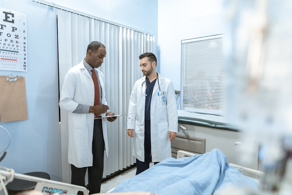 Two doctors review a patient's chart in a hospital room, focusing on healthcare cooperation and medical care