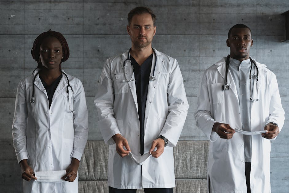 A diverse team of doctors in medical uniforms with stethoscopes in a hospital setting.